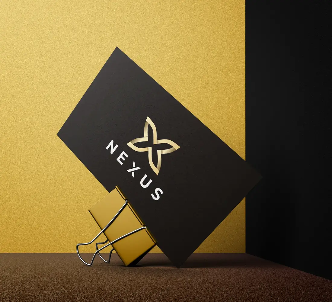 Business cards: black stock, gold foil mark.